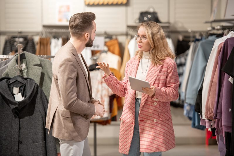 Stylist working with customer in shop