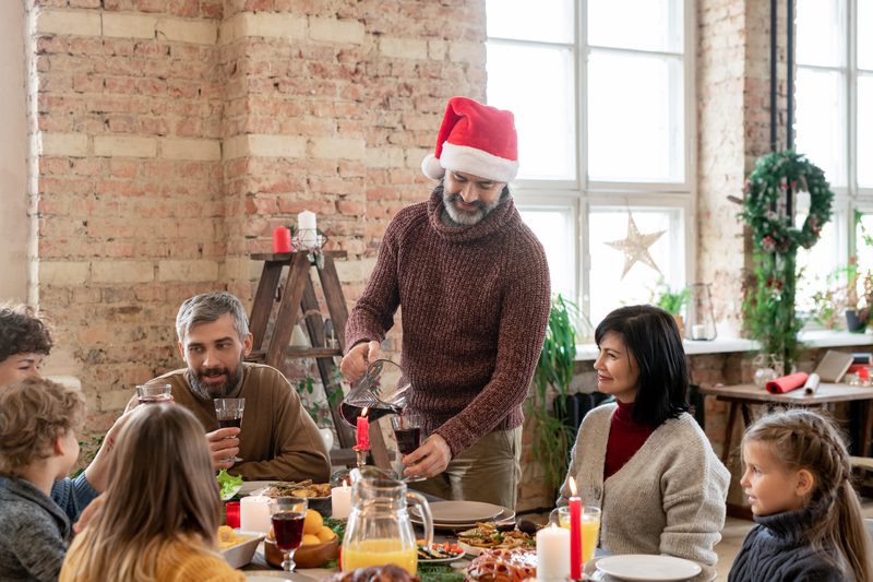 Man in cap pouring homemade drink Man in cap pouring homemade drink